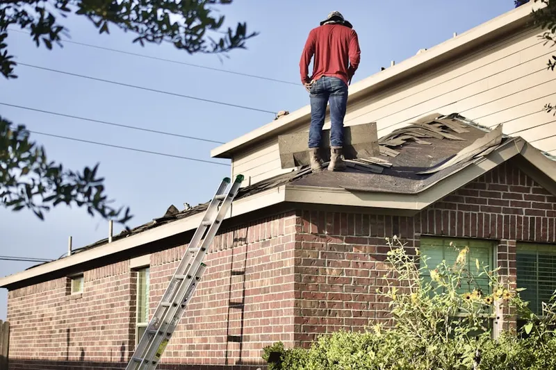 Professional roofer working on a residential roof in North Central Industrial